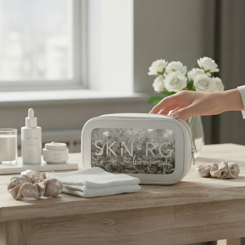 SKIN-RG skincare product set on a wooden table with a hand reaching for it.