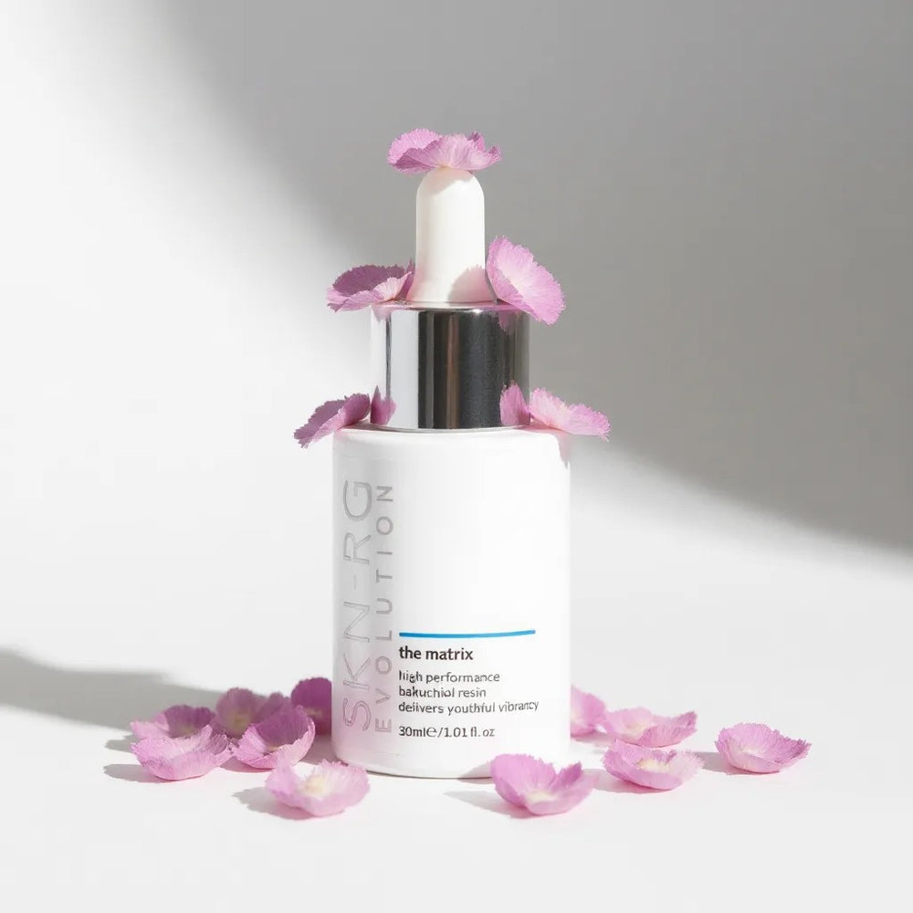 The Matrix Skincare bottle with pink flowers on a light background by skin-rg