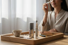 www.skin-rg.com Dermal Thinning Duo with Vitamin C serum and marine collagen cream, applied by a woman in a robe.