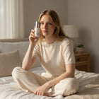 www.skin-rg.com hydra veil gel toner unlike standard toners is pulled into the skin to give hydration and prevent dermal thining bottle next to models face in bedroom with light shining on the side.