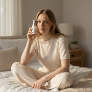 www.skin-rg.com hydra veil gel toner unlike standard toners is pulled into the skin to give hydration and prevent dermal thining bottle next to models face in bedroom with light shining on the side.