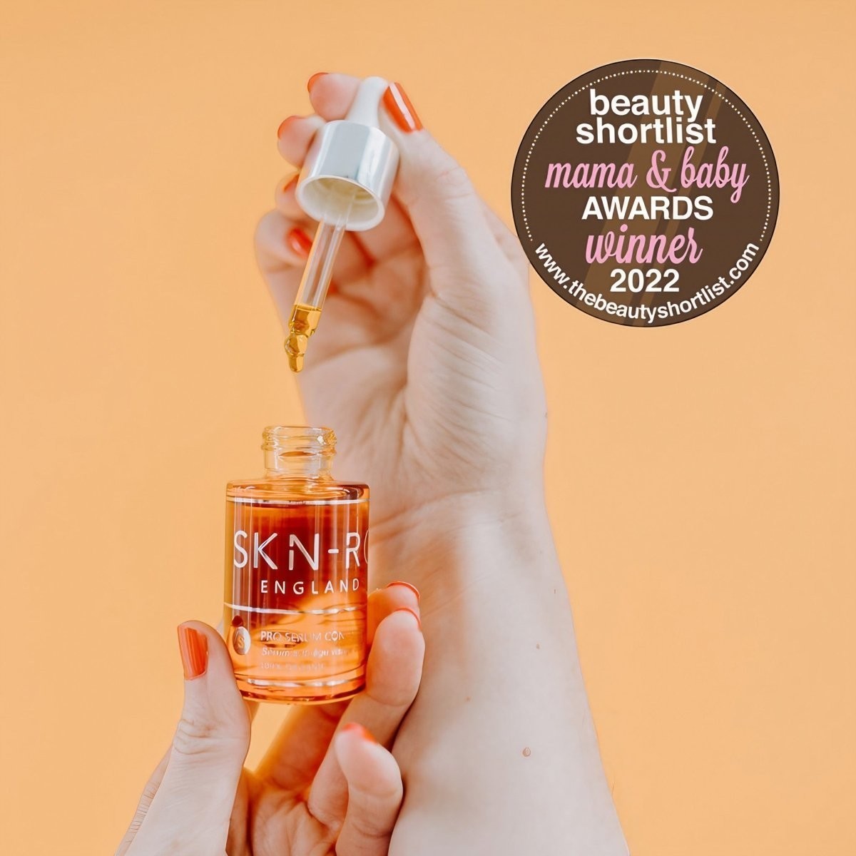 www.skin-rg.com Pro Oil Concentrate serum in a glass dropper bottle, featuring a golden oil and a 'Mama & Baby Awards Winner 2022' badge.