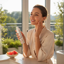 www.skin-rg.com woman applying serum to face, holding bottle of EXO VITALISE serum with visible lifting and firming benefits.