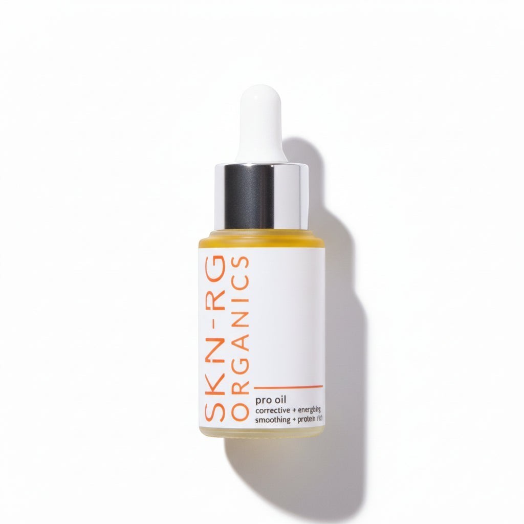 www.skin-rg.com Pro Oil corrective + energizing smoothing + protein rich serum in a clear glass bottle with a white dropper.